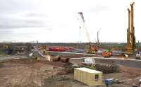 Braehead Viaduct works during the weekend line closure on 4th April 2015. Several small diameter piles are being driven where the ends of the viaduct will be; contractors have removed some sleepers but not the track itself to access the pile locations. In the foreground, two remaining 2m steel reinforcements await their turn to be sunk for the main supports.<br><br>[Colin McDonald 04/04/2015]