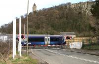 Looking north over Waterside level crossing, Causewayhead, on 31 March 2015. Having left Stirling station less than 3 minutes earlier, the 1320 ex Glasgow Queen Street is currently heading east towards Alloa. <br><br>[John Furnevel 31/03/2015]