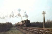 BR Standard tank 80021 climbs past the site of Clarkston East Junction on 8 April 1963 heading for East Kilbride. [Ref query 6574] <br><br>[John Robin 08/04/1963]