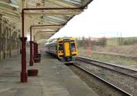 158860 calls at Hellifield with the 0926 Carlisle to Leeds service on 4th April 2015. The water column for S&C steam services stands alongside the loop while the area behind the train was the site of the steam shed. [See image 36032] from the same spot in 1970 before the shed was demolished.   <br><br>[Mark Bartlett 04/04/2015]