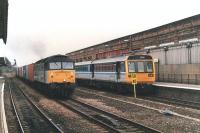 Freightliner 47301 powers along the bi-directional through line at Wakefield Kirkgate in September 1997 with a well loaded Intermodal working heading west to Crewe. Leyland Pacer 142072 stands at platform 2 on a terminating service from Sheffield.<br><br>[David Pesterfield 29/09/1997]