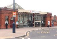 The glass exterior of the nicely refurbished booking hall at Llandudno station, seen here on 16 March 2015 from the station forecourt.<br><br>[Mark Bartlett 16/03/2015]