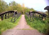 Looking South East towards Glastonbury on the Highbridge branch on 21 April 2014 [see image 47235]. This bridge over an edge-of-field watercourse features a narrow cyclepath and undercut brick pillars.<br><br>[Ken Strachan 21/04/2014]