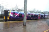 An Edinburgh bound TransPennine service awaiting departure from a rain swept Wigan on 12 April 2015.<br><br>[John Steven //]