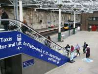 The escalator alongside platform 11 linking the Waverley west end concourse with the cross-station walkway. This oddly angled addition was brought into use at the end of 2013. Long term plans for the extension of platform 12 could mean its days are already numbered - along with those of the building in the right background. Standing at the west end of platform 11 on 14 April 2015 is the 1100 to Glasgow Queen Street.<br><br>[John Furnevel 14/04/2015]