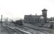 Black 5 no 45007 passing Ardrossan North on 5 July 1959 with a train for Montgomerie Pier. The train has just passed the large Shell refinery in the left background. Ardrossan North station had been closed since 1932, although Montgomerie Pier survived until 1967. The refinery closed in 1986. [See image 23867]<br><br>[G H Robin collection by courtesy of the Mitchell Library, Glasgow 05/07/1959]