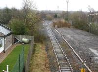 The bottom end of Millerhill Yard looking south past the former station on 12 April 2015. With the new recycling depot on the north west corner of the yard now accessible from the north, the temporary route for construction traffic has been closed and the landscape restored [see image 47809]. <br><br>[John Furnevel 12/04/2015]