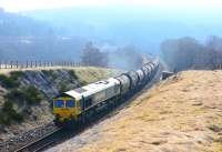 Freightliner 66602 emerges from the haze around Slochd Viaduct on 9 April with the cement train for Inverness.<br><br>[John Gray 09/04/2015]