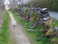The 3 foot gauge Skye Marble Railway ran 4 miles from Broadford pier to the quarries at Kilchrist with a Hunslet 0-4-0ST providing the motive power, but only lasted from 1908 to 1913. Looking south along the coastal trackbed at Broadford in April 2015.<br><br>[Bill Roberton 16/04/2015]