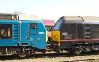 67003, 67006 and the DB badge on a passing class 66, photographed at Didcot on 15 April 2015.<br><br>[Peter Todd 15/04/2015]