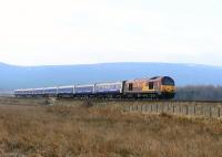 The Northbound Inverness portion of the Caledonian Sleeper hauled by 67030 almost at the end of its journey as it crosses the moor at Moy on 9 April 2015.<br><br>[John Gray 09/04/2015]