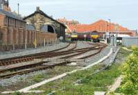 Looking east towards Whitby station on 13 April 2015 with a NYMR service in platform 1 on the left and a railtour from Chester at platform 2. Platform 2 was re-instated in 2014 and includes a run round loop to release a locomotive, although on this occasion both trains were top and tailed. The NYMR train has Class 25 D7628 with Black 5 no. 45407 at the other end, while the railtour has 66142 nearest and 66005 at the buffers.<br><br>[John McIntyre 13/04/2015]