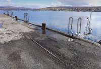 Surviving rails of the Skye Marble Railway on the pier at Broadford on 16 April 2015 [see image 51016].<br><br>[Bill Roberton 16/04/2015]