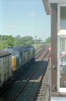 The signalman looks on as 37242 reverses having drawn a train out from the siding at Lugton. After reversing, the train was pinned down on the main southbound line and the leading two vans drawn forward again and reversed back into the siding.<br><br>[Ewan Crawford //1989]