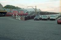 Cars and vans unloaded in the sidings which were located next to the Bathgate terminus. This site is now a retail estate. The closed terminus station was to the left and the view looks east.<br><br>[Ewan Crawford //1988]