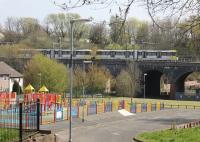 A double tram runs across Smedley Viaduct on its way from Rochdale to East Didsbury on 20 April 2015. The trams are taking the chord up to Irk Valley Junction but the other bridge still carries tracks as the old Cheetham Hill line is used to access Queens Road Metrolink depot. This image taken from the end of Queens Road platform.  <br><br>[Mark Bartlett 20/04/2015]