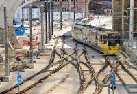 The temporary single Metrolink track through Manchester Victoria has been replaced by a complex junction for the <I>second city crossing</I> that is under construction. Metrolink 3043 negotiates the pointwork as it enters the covered area in April 2015. [See image 49303] taken six months earlier. <br><br>[Mark Bartlett 20/04/2015]