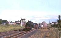 Grangemouth based standard class 5 4-6-0 no 73007 passes through Braidwood, Lanarkshire, with a down freight in the summer of 1965.<br><br>[John Robin 16/07/1965]