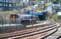 View south over the sidings alongside Oban station on 22 April 2015 as 156450 pulls away from platform 2 and heads for Albany Street bridge with the 1211 service to Glasgow Queen Street. This train combines with the 1010 ex-Mallaig at Crianlarich. [See image 40271]<br><br>[John Furnevel 22/04/2015]