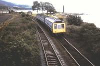 A Glasgow to Largs DMU approaching its destination in May 1984, taken from the overbridge. The road on the left is Rockland Park. The Pencil stands in the background. [See image 51154]<br><br>[Colin Miller /05/1984]