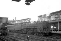 Kingmoor based Britannia Pacific 70033, minus its <I>Charles Dickens</I> nameplate, recently arrived at Carlisle on 24 July 1965 with the 9.30am Dundee - Blackpool North. The locomotive waiting on the centre road is Upperby Black 5 44906.<br><br>[K A Gray 24/07/1965]