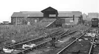 By 1970, builder's merchants J T Dove Ltd had put their stamp on the roundhouse at Tweedmouth, with a new entrance formed through the north wall and a large sign proclaiming ownership. Access to the central turntable had been through an archway, by now blocked up, in the centre of the wall [see image 51011].<br><br>[Bill Jamieson 19/09/1970]
