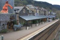 Strange creatures at Betws-y-Coed on 14th April 2015. Edith, the Bottle Top Rhino waits on the platform to inform bemused visitors about the plight of her relatives in South Africa while resident Red Dragons (see inset) look down from the roof.<br><br>[Colin McDonald 14/04/2015]