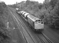 25227 with a Thornton - Mossend freight formed of six Tullis Russell hoppers and a well wagon about to take the Winchburgh line at Dalmeny Junction in March 1982.<br><br>[Bill Roberton /03/1982]