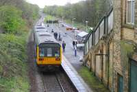 Daisy Hill is on the former four track direct line from Wigan to Manchester but trees now grow where the fast lines were. In L&YR days expresses from Manchester to Liverpool raced through here. Northern Pacer 142037, heading for Manchester Victoria from Kirkby, calls at the station. <br><br>[Mark Bartlett 25/04/2015]