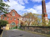 The  south west face of what remains of Edinburgh Corporation's tram depot and works in May 2015. The now detached power house chimney is probably not tall enough to qualify as a landmark but I hope it stays (and it has done remarkably well so far). The bridge I'm standing on crosses the Powderhall branch.<br>
<br><br>[David Panton 11/05/2015]