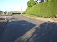 A single track still remains in situ across the road at the former double track level crossing on Station Road in Stalbridge, Dorset, on what appears from maps to be the exact route of the Somerset & Dorset line. It can also be seen continuing under the tarmac surface heading into the building supplies premises off to the right.<br><br>[David Pesterfield 12/05/2015]