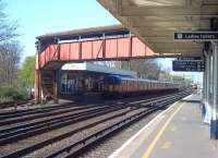 A westbound South West Trains service pauses at Platform 3 of Raynes Park station on 15 April 2015. The station has two island platforms.<br><br>[Andrew Wilson 15/04/2015]