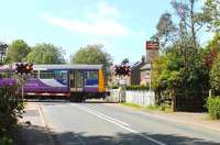 142012 crosses the B5259 and slows for the Moss Side stop on a Colne to Blackpool South working on 16th May 2015.<br><br>[Mark Bartlett 16/05/2015]