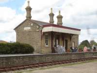 The former terminus station at West Bay, at the end of the short lived extension south from Bridport on the branch line from Maiden Newton, seen on the afternoon of 12 May 2015. The building now houses 'The Station Cafe' with tables also sited along the platform when the weather is good. A length of track runs alongside the platform over its full length. <br><br>[David Pesterfield 12/05/2015]