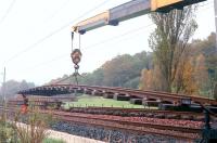Track lifting in progress during singling of sections of the Milngavie<br>
branch in 1990. Scene just north of Hillfoot station.<br><br>[Ewan Crawford //1990]