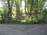 Not only are the south side gate posts extant at the former Henstridge Station level crossing [see image 51312], but a matching pair can also be found on the north side. These come complete with a gate from decades past, as seen in this view on 12 May 2015.<br><br>[David Pesterfield 12/05/2015]