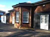 The original station at Hampton-in-Arden, was opened by the London & Birmingham Railway in 1838 as plain Hampton. It sat well back from the track and looked similar to a toll keeper's cottage on a turnpike road. It is several hundred yards from the current station, which replaced it in 1884. The old station building is seen here in May 2015 in use as offices. [Ref query 9917] <br><br>[Ken Strachan 12/05/2015]