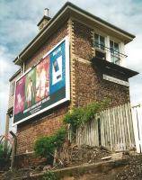 Two bygones for the price of one: Grangemouth Junction signal box and cigarette advertising. Photographed in July 1996. [See image 28916]<br><br>[David Panton /07/1996]