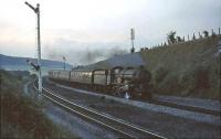 Possibly the last shot of the day at West Wycombe as night begins to fall on a late summer evening in August 1964. The passing train is a Birkenhead - Paddington express and the locomotive is Tyseley based 7026 <I>'Tenby Castle'</I>.  <br><br>[John Robin 28/08/1964]