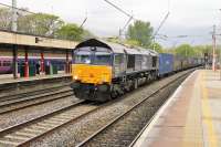 <I>Life in the fast lane</I>. DRS 66421 takes the Up Fast Line through Lancaster (Castle), ensuring a flying start to the climb of the bank that lies south of the station. The train is the 429P 0428 Coatbridge to Daventry container service.<br><br>[Mark Bartlett 19/05/2015]