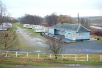 The former station building at Bankfoot, Perthshire, looking south from the village war memorial in December 1990. The former terminus of the short-lived Bankfoot Light Railway (1906-1931) was then in use as a caravan park. The site is now covered by a housing estate.<br><br>[Ewan Crawford //1990]