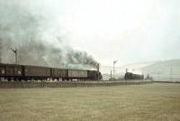 A parcels train hauled by Black 5 45364 is about to pass classmate 45126 with a freight on the WCML at Elvanfoot in the spring of 1966.    <br><br>[John Robin 25/03/1966]