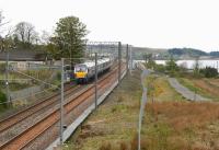 After passing Forrestfield westbound on 15 May 2015 the 1048 Edinburgh Waverley - Helensburgh Central is about to skirt the south shore of Hillend Reservoir before making its next stop at Caldercruix.<br><br>[John Furnevel 15/05/2015]