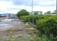 The Caledonian's Leith North branch (closed 1962) has long been coverted to a cycleway - except for the last couple of hundred yards where things fall apart badly. The path currently (May 2015) ends abruptly after the Lindsay Road overbridge and the approach to the terminus was built over by a small industrial estate many years ago (to the right of the shrubbery). The station building itself was demolished more recently and flats now occupy the site. [See image 45699] for a similar view in 1962.<br>
<br><br>[David Panton 24/05/2015]