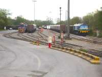 Aggregate Industries super GM shunter No 44 <I>Western Yeoman II</I> has just backed onto a rake of Mendip Rail bogie box wagons at Merehead on 8 May 2015 ready to move them to the loading facility. On the right AI liveried 59005 waits at the rear of a loaded rake ready to propel it out of the yard onto the branch before heading off to join the main line.<br><br>[David Pesterfield 08/05/2015]