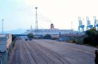 QE2 seen over the site of the shed at Greenock Princes Pier, later the<br>
containerbase, in 1990.<br><br>[Ewan Crawford //1990]