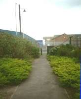 In April 1995 there was a path on the trackbed of the approach to the Bath Road crossing, which was once busy enough to warrant a footbridge. In May 2015 the path is no more, with palisade fencing on this side of the road too, the shrubbery now impenetrable and the yard lamp and pole gone. [See image 19652] for a view of the crossing in 1985, when the buidings were still in place.<br>
<br><br>[David Panton 18/04/1995]