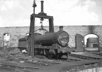 The roofless roundhouse at Tyne Dock might have been ideal for the railway photographer but it can't have been much fun for shed staff working on locos inside it - the afternoon of Saturday 3rd September 1966 was pleasant enough as Q6 No. 63377 basks in the sun under the shear legs, but just imagine what it must have been like with rain driving in off the North Sea.<br><br>[Bill Jamieson 03/09/1966]