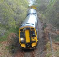 158702 southbound towards Inverness on 16 May about to go under the A9 at The Mound alongside the River Fleet. The train is the 1234 ScotRail service from Wick / Thurso.<br><br>[Brian Smith 16/05/2015]