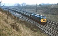 A very gloomy 1st March 1975 finds 45143 <I>5th Royal Inniskilling Dragoon Guards</I>  approaching Glendon Junction on the long sweeping curve from the Market Harborough direction, with the line from Corby and Manton Junction at a lower level on the right. The train is the 14:10 (ish) Derby to St Pancras. <br><br>[Bill Jamieson 01/03/1975]